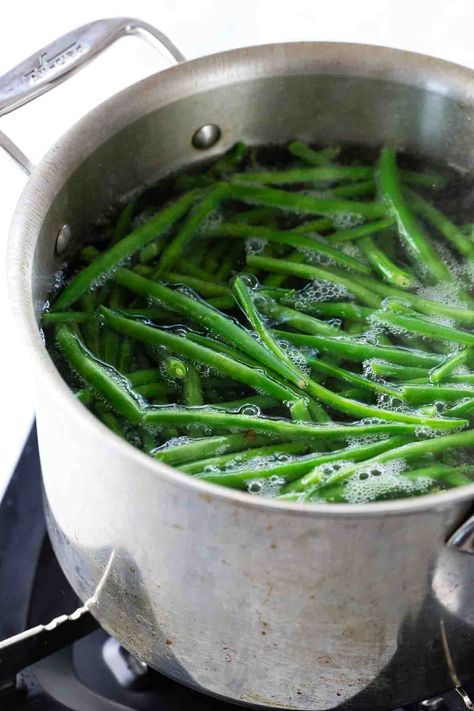 Master how to cook green beans and achieve the perfect texture and color every time. The simple blanch and shock method is the key to bright and crunchy beans. Boiled Green Beans Recipe, Crunchy Beans, Garden Green Beans, Cook Green Beans, Boil Green Beans, Cooking Fresh Green Beans, Blanching Green Beans, How To Cook Greens, Cooking Green Beans