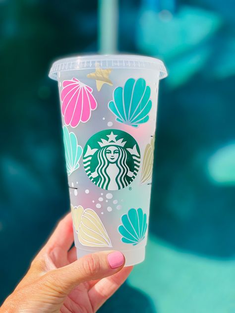 Enjoy your favorite beverages in style with our exquisite handcrafted seashell cup. This beautifully designed seashell cup is not just a functional drinkware item but also a piece of art that captures the natural beauty of the sea.  This imaginative Starbucks seashell-inspired cup is a must-have for Starbucks collectors and beach enthusiasts. Add a touch of coastal charm to your morning routine or make it a delightful gift for your fellow Starbucks lovers. Enjoy a sip of the sea with every brew! **Please message with any questions**  *Only ships to United States from Bakersfield, California Rush order please add the Rush Order Listing to Your cart before check out, Jump ahead in line Care Instruction Hand Wash Only Not Microwave or Dishwasher Safe Do not scrub or soak  Please follow us on Beach Cups, Summer Cups, Beach Wedding Gifts, Bakersfield California, Starbucks Lovers, Beach Lover Gifts, Coastal Charm, Starbucks Drinks, Cute Cups