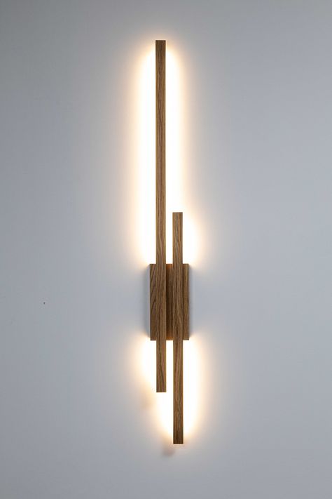 minimalist wooden linear wall lamp ambient light WAND TWO Modern Oak high quality handcrafted  WAND TWO lamp is a minimalist wall lamp with a simple and modern design. It consists of a long and short, horizontal wooden elements that attaches to a square bracket, which serves as the wall mount. The lamp emits soft, warm light directed downward, creating a gentle illumination effect on the wall below. The entire construction has a sleek, contemporary appearance and is made from natural oak wood, g Wand Lamp, Living Room Wall Lighting, Wall Bracket Light, Living Room Wall Lights, Ambient Lamp, Wooden Wall Lamp, Wood Wall Lamp, Wooden Wall Lights, Indoor Wall Light