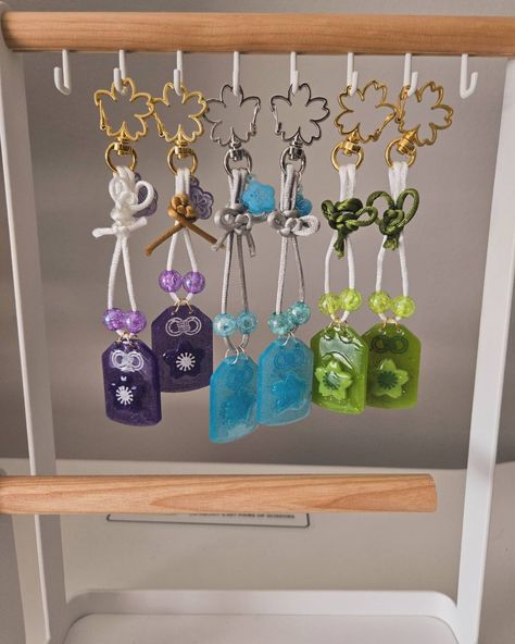 Omamori keychains ✨️🧧 I like making these but those knots are hard to make 😅 . . . #resinartist #resinkeychains #resin #omamori #smallbusiness Omamori Diy, Keychains, Quick Saves