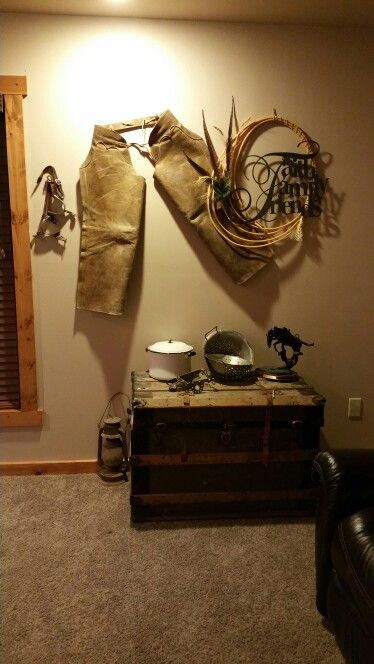 Western wall decor with chaps, spurs, and rope. Cowhide Wall Decor Ideas, Saddle Wall Decor, How To Display Cowboy Chaps, Western Kitchen Wall Decor, Cowboy House, Rustic Cowboy Decor, Farmhouse Style Living Room Decor, Eclectic Decor Vintage, Cowhide Decor