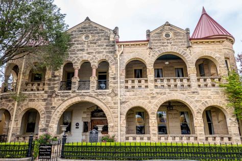 Limestone home with arches along the porch and balcony and red turrets on both ends Kerrville Texas Things To Do, Home With Arches, Kerrville Texas, Texas Vacation, Guadalupe River, Texas Vacations, Texas Roadtrip, Community Theater, Porch And Balcony