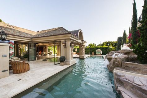 This European-style villa's extravagant outdoor living spaces include two lagoon pools, a grotto-style spa and a huge slide. Partially Covered Pool, Cottage Pool, Covered Pool, Elegant Pool, European Cottage, Luxury Swimming Pools, Homes Ideas, Swimming Pool House, Storage Inspiration