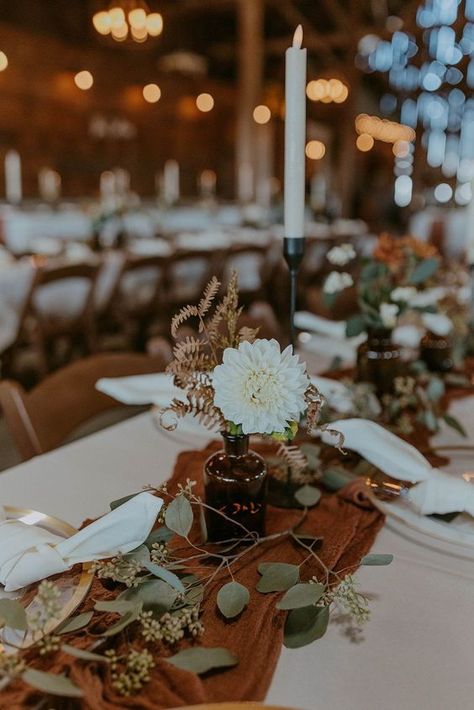 Rustic Terracotta Wedding Table Decor, Amber Vases With Flowers, Rust Wedding Decor Table, Terracotta Centerpieces Wedding, Terracotta Table Runner With Greenery, Eucalyptus Fall Wedding Table Decor, Floral Arrangements Fall Wedding, Rust Wedding Details, Sage Green And Terracotta Wedding Reception