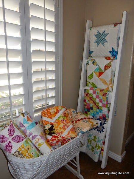 Decorating with Quilts | A Quilting Life - a quilt blog Ways To Display Quilts, Decorating With Quilts, Quilt Shop Displays, Armoire Decor, Tiny Quilts, Antique Crock, A Quilting Life, Quilt Ladder, Tree Fabric