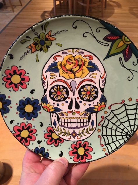 Sugar skull salad plate! Color me mine, Hillsboro. #sugarskull #pottery Skull Pottery Painting Ideas, Sugar Skull Ceramic, Underglaze Designs, Sugar Skull Painting, Painting Pottery, Pottery Patterns, Pottery Design, Color Me Mine, Clay Plates