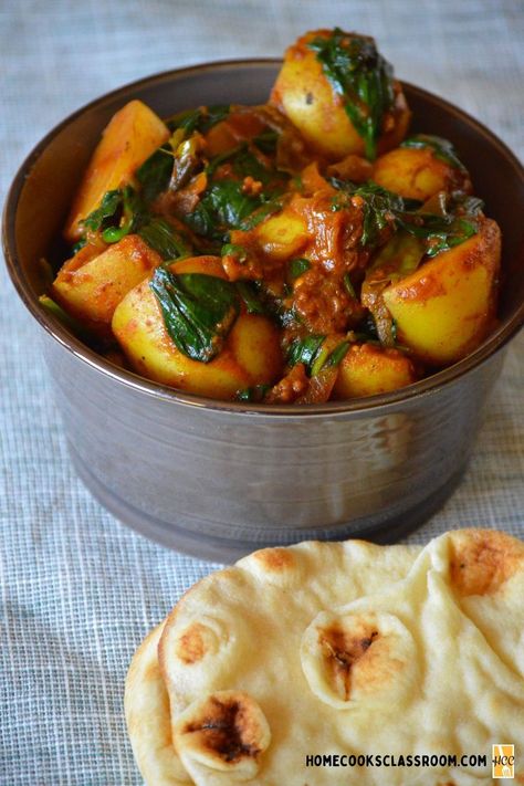 Saag aloo is a classic vegan Indian dish consisting of potatoes and spinach. It can vary from region to region, with the most common featuring minced spinach sauce. However, our recipe is a more unique version with a spiced tomato sauce, with whole spinach. It is so flavorful and filling making it a great centerpiece to a vegetarian meal. Vegan Indian Dishes, Indian Spinach, Potatoes And Spinach, Saag Aloo, Spinach Sauce, Green Chilis, Tomato Dishes, Spinach Tomato, Cumin Seeds