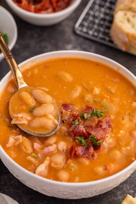 Bean with Bacon Soup Whip up a bowl of cozy, nostalgic Bean with Bacon Soup, made from simple ingredients that come together to create a hearty blend of creamy white beans and smoky bacon. This homemade, flavorful delight is easy to prepare and undoubtedly better than any canned version you've tasted before. Bacon Bean Soup Recipes, Copycat Campbell's Bean With Bacon Soup, White Bean Bacon Soup, Creamy Bacon And White Bean Soup, White Bean Soup With Bacon, Homemade Bean And Bacon Soup, Bean Bacon Soup Recipes, Bean And Bacon Soup For Canning, Creamy Bean Soup With Kielbasa