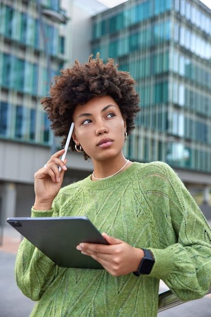 Free photo woman keeps stylus on temple ... | Free Photo #Freepik #freephoto #working-women #stylus #using-tablet #technology-woman Graphic Tablet, Green Jumper, Social Media Branding Design, Green Jumpers, Photo Woman, Graphic Design Assets, Studio Photography Poses, Marketing Photos, Study Photography