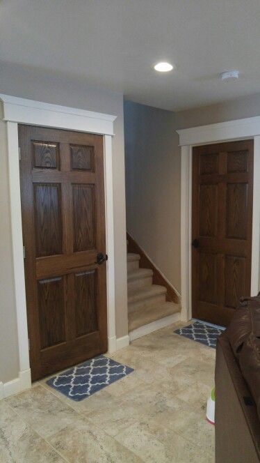 Wall Trim And Door Colors, Dark Wood Doors With White Trim, Dark Stained Doors With White Trim, White Trim With Stained Doors, Brown Doors White Trim, Dark Brown Interior Doors, Stained Doors With White Trim, Oak Doors With White Trim, Dark Stained Doors