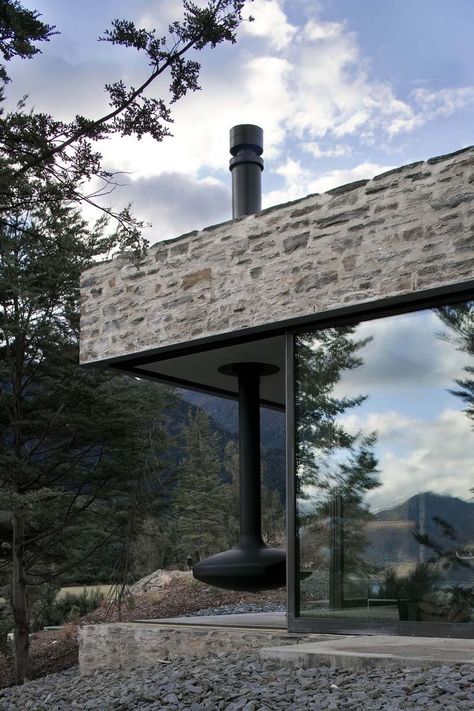 designed by Fearon Hay Architects, nestled high on a mountain next to Lake Wakatipu on the South Island of New Zealand. Plans Architecture, Stone Facade, Glass Walls, Design Exterior, Mountain Retreat, Architecture Exterior, Stone Houses, Stone House, Facade Design