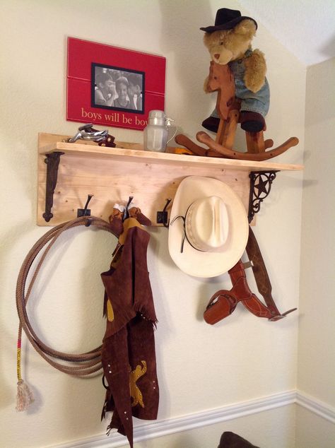 Texas Cowboy Nursery - This handcrafted wooden shelf was made by the little cowboy's grandparents. White pine craft wood (Lowe's) was given an aged look by applying Annie Sloan's dark wax. Treasured items from the little cowboy's great grandfather are displayed. The Texas Star shelf brackets were purchased on eBay. The "Boys Will be Boys" photo frame was purchased at a local baby boutique. Western Little Boys Room, Cowboy Playroom, Cowboy Baby Room, Nursery Ideas Cowboy Western Theme, Old Western Nursery Theme, Cowboy Nursery Baby Boy, Boys Cowboy Room, Cowboy Themed Nursery, Baby Nursery Ideas For Boy Country Cowboy Room Western Theme