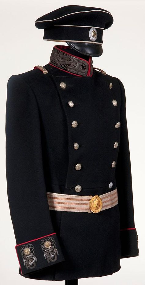 Imperial Russian Navy officer's uniform group, circa 1910. Includes Tunic, cap and belt.  Made of black wool double breasted tunic with red piping and richly embroidered silver bullion anchor motifs on the collar and cuffs. Visor cap of black wool with white piping and black leather visor, with officer's pattern cockade on the band. Group also includes a silver brocade belt with mixed orange and black, and a gold spoon and wreath Navy buckle. Navy Officer Uniform, Officer Uniform, Alexei Romanov, Russian Clothing, Military Dresses, Navy Uniforms, Military Looks, Uniform Dress, Army Uniform