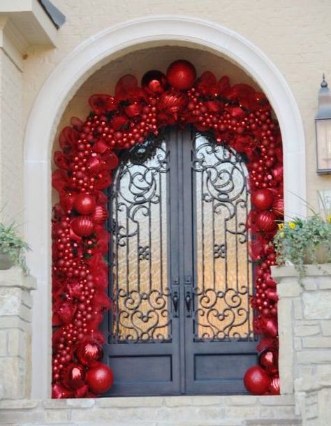 This impressive display requires quite a few ornaments (to put it mildly). If you don't have a few hundred matching red balls, a small take can look just as lovely. La Christmas, Christmas Door Decoration, Front Door Christmas Decorations, Elegant Christmas Decor, Christmas Tablescape, Christmas Front Porch, Christmas Front Doors, Have Inspiration, Xmas Ideas