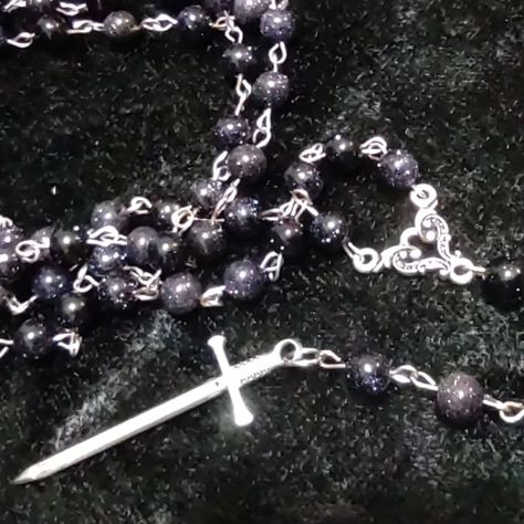 This blue goldstone rosary looks like it's made of tiny universes strung together. When in proper light, goldstone lives up to its name. #sword #rosary #spooky #goth #gothic #goldstone #beadjewelry Blue Gothic Aesthetic, Rosary Aesthetic, Gothic Rosary, Silly Creature, Fantasy Dagger, Powerful Witch, Rosary Style Necklace, Blue Rosary, Last Unicorn