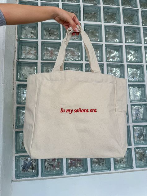 Because the Señora era is the best era! 100% cotton canvas / Red design Embroidered with love by JZD in Brownsville, TX Inside pocket  Measurements Tote bag: 14" x 14"  Depth: 5.5" Handles: 11" Senora Life, Canvas Bag Design, Bag Quotes, Embroidered Tote Bag, Boys Tops, Embroidered Tote, Cute Shirt Designs, Shirt Design Inspiration, Red Embroidery