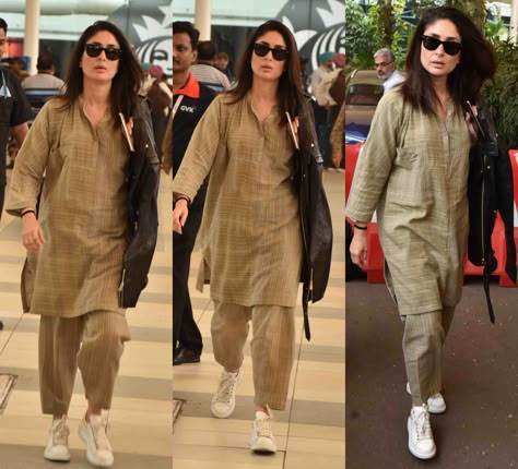 Kareena Kapoor was snapped at the airport recently wearing a cotton kurta set paired with white sneakers. She carried a black leather jacket over her shoulders and finished off her look with a pair of sunglasses, minimal makeup and straight hair! Kurti With Sneakers, Kurta With Sneakers, Cotton Kurta Set, Indian Celebrity, Vintage Shirt Dress, Pakistani Fashion Casual, Casual Indian Fashion, Pakistani Dresses Casual, Minimal Makeup