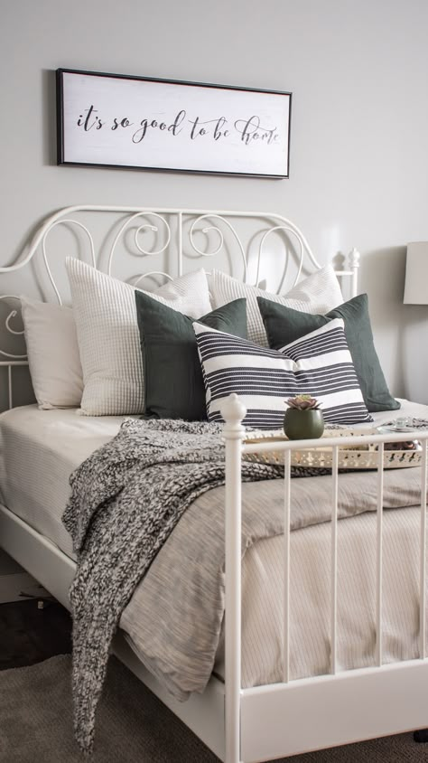 White & Grey Bedroom. Bedroom designed and styled with Ikea bedframe, toss cushions, & linens. Cozy and modern, great for a guest bedroom. Wall colour is Benjamin Moore Gray Owl. Airdrie, AB, Rocky View County, AB. eDesign. Leirvik Bedframe. #bedroomstyling #bedroomdesign #whitebedframe #ikeacanada #sparebedroomdecor #greendecor #grayowl #whtietosscushions #whitepillows #blackandwhite #blackandgrey #whiteandgrey #whiteandgreybedroom #whiteandgreenbedroom #greyandgreenbedroom #whitegreygreen Ikea Bedframe, Ikea Metal Bed, White Grey Bedroom, Ikea Style Bedroom, Grey Green Bedrooms, Benjamin Moore Gray Owl, White Iron Beds, Ikea Bedding, Ikea Bed Frames