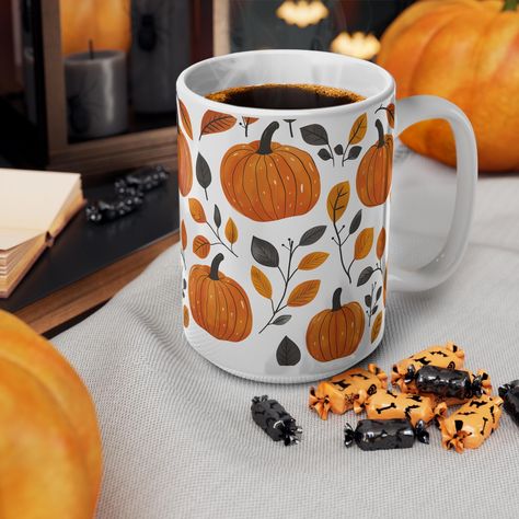 Embrace the warm and cozy vibes of autumn with our Pumpkin Inspired Autumn Mug. Featuring a beautifully illustrated pumpkin in neutral tones, this ceramic mug is the perfect addition to your fall drink ware collection. Whether you're sipping on hot cocoa, spiced lattes, or herbal tea, this mug brings the essence of the season to every sip. Designed with a sleek and elegant look, it's a great gift for pumpkin lovers, coffee enthusiasts, and anyone who loves the magic of autumn. Ideal for cozy mor Pumpkin Mug Painting, Autumn Pottery Painting, Autumn Ceramics, Cute Fall Mug, Pumpkin Ceramic Mug, Autumn Coffee Mugs, Autumn Mug Design, Fall Mugs, Autumn Mugs