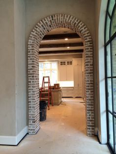 Shiplap Doorway, Brick Archways In Homes, Brick Arch Entryway, Brick Arch Doorway, Archway Door, Brick Wall Arch, Arch Hallway, Brick Arch With Wood Beam, Doorway Ideas