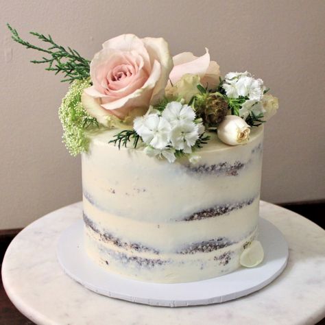 A romantic, garden-inspired, semi-naked cake adorned with an abundance of fresh flowers and greenery. Designer’s choice of flowers depending on healthiest flowers available at our local floral market. Custom color choice can be requested in your email (flower type will be baker's choice). → For more information, check out our size guide, flavor guide, color swatch, and cake stand size recommendations, and FAQs. Floral Market, Wedding Cake Tops, Small Wedding Cakes, Fresh Flower Cake, Flowers And Greenery, Elegant Cakes, Tiered Wedding Cake, Floral Cake