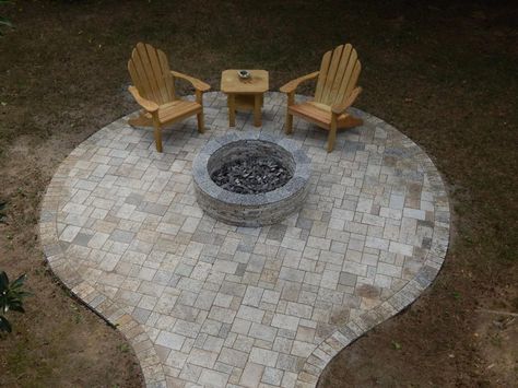 The versatility of pavers can enable homeowners to create a circular design around a fire pit, or other shapes, such as a square space, for entertaining day or night. These pavers are made of recycled granite. Fire Pit With Pavers, Circular Fire Pit, Circle Patio, Paver Fire Pit, Outdoor Fire Pit Area, Diy Patio Pavers, Paving Ideas, Paver Designs, Patio Pavers Design