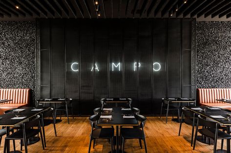 The CAMPO Modern Grill Was Designed With Hand-Laid Black Pebble Accent Walls Grill Restaurant Design, Restaurant Grill, Natural Oak Flooring, Black Restaurant, Chaise Restaurant, Wroclaw Poland, Grill Restaurant, Modern Restaurant, Terrazzo Flooring