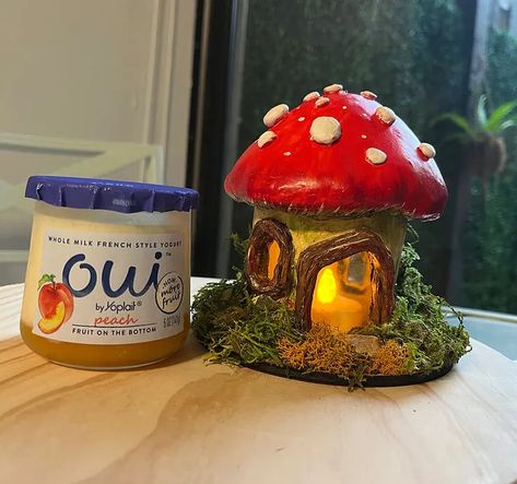 How to Recycle Oui Yogurt Jars — Create a Mushroom Fairy House! | by The Majestic Loot | Medium Diy Clay Fairy Garden Accessories, Polymer Clay Fairy House Diy, Air Dry Clay Mushroom Jar, Air Dry Clay Stash Jar, Air Dry Clay Jar Ideas, Oui Jars Repurpose, Clay Mushroom Jar, Tiny Jar Crafts, Oui Yogurt Jars Ideas