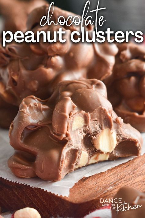 close-up photo of a chocolate peanut cluster with a bite out of it Microwave Peanut Clusters Recipe, Microwave Peanut Clusters, Microwave Candy, Chocolate Crackles Recipe, Xmas Snacks, Potluck Favorites, Chocolate Peanut Clusters, Chocolate Clusters, Chocolate Crackles