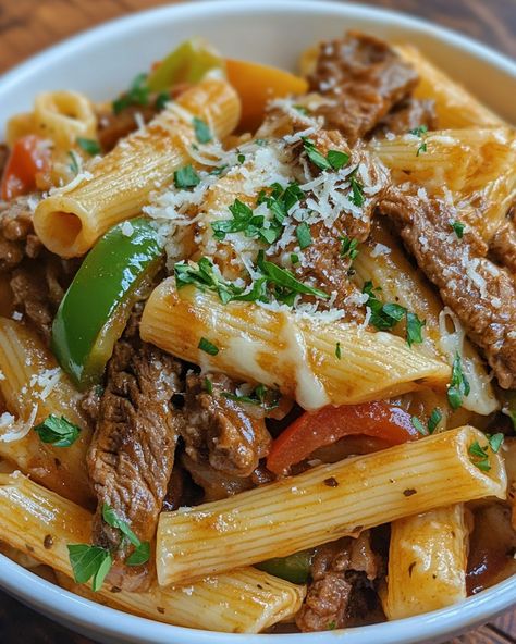 🧀 Philly Cheesesteak Pasta 🧀 Ingredients - 8 ounces pasta (penne or rigatoni) - 1 tablespoon olive oil - 1 small onion, sliced - 1 bell pepper, sliced (green or red) - 1 pound thinly sliced beef (sirloin or flank steak) - Salt and pepper, to taste - 2 cups beef broth - 1 cup cream cheese, softened - 1 cup shredded provolone or mozzarella cheese - 1 teaspoon garlic powder - 1 teaspoon Worcestershire sauce - Fresh parsley, chopped (for garnish) Instructions 1. Cook the pasta according to p... Sirloin Steak Lunch Recipes, Steak Lunch Recipes, Cheese Steak Pasta, Philly Cheesesteak Pasta, Steak Lunch, Cheesesteak Pasta, Steak Pasta, Pasta Penne, Cheese Steak