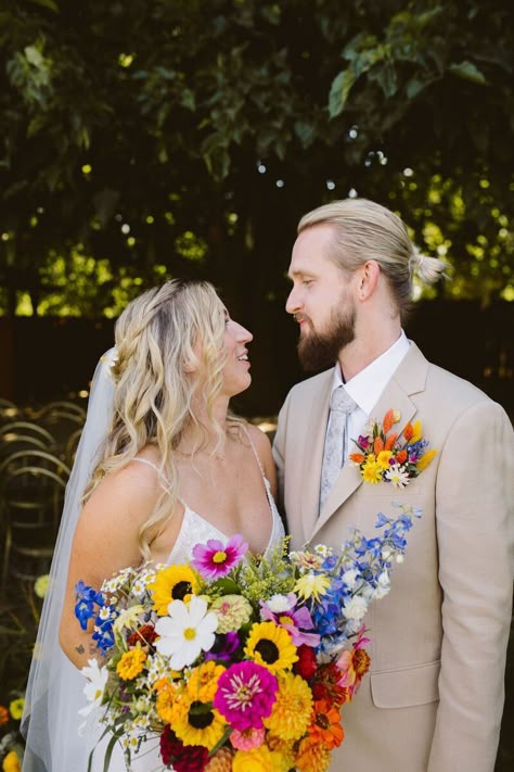 ​This vibrant and funky wildflower wedding at Ojai Rancho Inn was ​eclectic, bold,​ whimsical, artistic, and fun! Our musician bride had a colorful statement ​bridal ​bouquet with ​a rainbow of ​summer wildflowers and sunflowers​. ​Our groom wore a ​colorful ​floral pocket​ boutonniere​!​ Dried ​wildflowers ​hung ​from trees, 400 sunflower heads floated in the pool, and guest dined al fresco under string lights. ​​Photographer: The Shalom Imaginative . Pocket Boutonniere Wildflower, Whimsical Wedding Groom, Wildflower Wedding Suit, Wild Flower Wedding Groomsmen, Sunflower And Wildflower Wedding, Fall Rainbow Wedding, Summer Wildflower Bouquet Wedding, Colorful Wedding Groom, Wildflower Groomsmen Attire