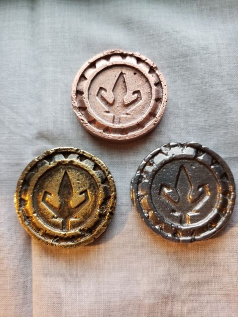 Custom trident coins in copper, brass and aluminum Fantasy Coin Design, Coins Aesthetic, Fantasy Money, Fantasy Coins, Magic Coins, Pirate Coins, Currency Design, Custom Coins, Event Props