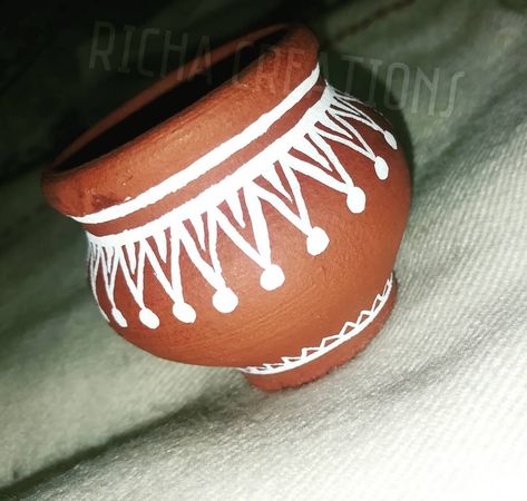 Mini pot painting 🎨 white on geru, traditional and folk feel, "Madana"..🖌️ #madana #folkart #geruwork #potpainting🎨 #artistsofinstagram… Warli Art On Pots Terracotta, Simple Pot Designs, Terracota Pots Painting, Warli Paintings On Pots, Pots Design Ideas Paint, Mini Pot Painting, Mini Pot Painting Ideas, Simple Pot Painting, Matki Painting Ideas