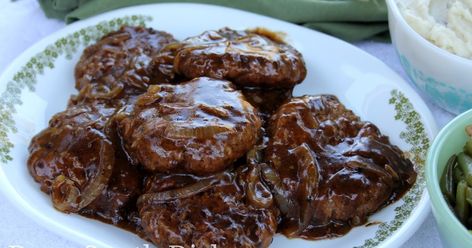 Hamburger Steak with Creamy Onion Gravy is a diner classic and a southern favorite. Seasoned ground beef patties are cooked with caramelized onion and gravy for a real belly-pleaser. Hamburger Steak And Gravy, Hamburger Steaks, Kitchen Bouquet, Deep South Dish, Hamburger Steak, Onion Gravy, Steak Marinade, Salisbury Steak, Deep South