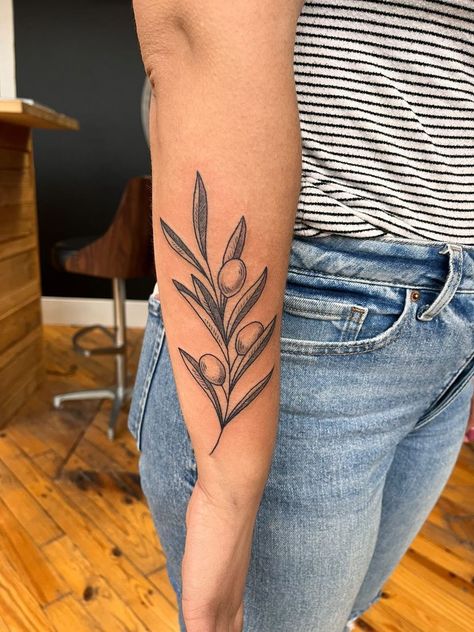 Girl with tattoo Olive Branch Shoulder Tattoos For Women, Green Olive Branch Tattoo, Lettered Olive Shell Tattoo, Neo Traditional Olive Branch, Olive Branch Tattoo Color, Leaf Tattoo Traditional, Olive Branch Leg Tattoo, Traditional Olive Branch Tattoo, Olive Branch Wrap Around Tattoo