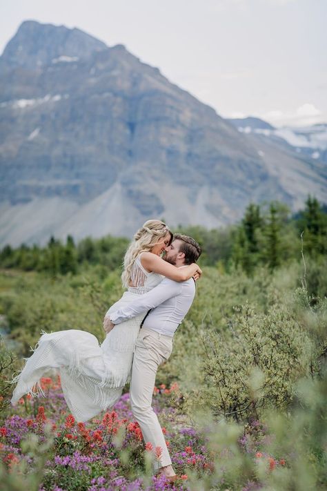 Newlywed couple frolicking in field of wildflowers beside highway on Icefields Parkway in Banff National Park.  Boho mountain elopement on Icefields Parkway. Where to elope in Banff National Park. Where to have an intimate wedding ceremony in Banff national Park. Most Scenic wedding ceremony venue in the mountains. Mountain destination wedding. Most beautiful places in the world to get married. Where to get married in the mountains. Peyto Lake Elopement Photographer. Boho Mountain wedding inspir Moraine Lake Wedding, Boho Mountain Wedding, Peyto Lake, Boho Mountain, Scenic Wedding, Mountain Wedding Photos, Field Of Wildflowers, Icefields Parkway, Mountain Adventure