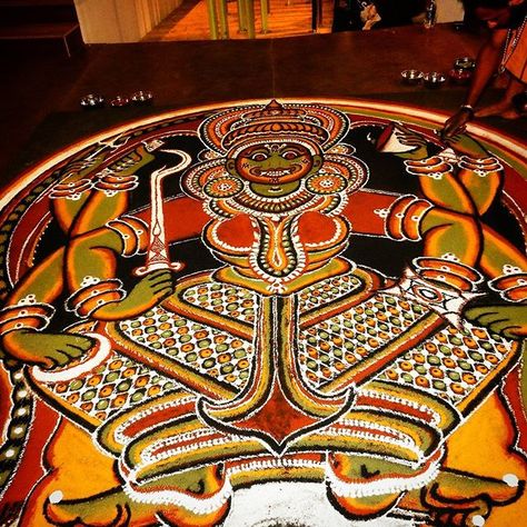 Kalamezhuthu is a ritual art form found in Kerala. While it is thought of to be similar to other forms like Rangoli, Kolam etc. it is not entirely so.  A form of temple art also done in sacred groves, Kalamezhuthu is normally done to worship goddesses ( Devi), serpents (Naga) and Lord Ayyappa (Sastha). Usually the ritual art is performed at the thresholds. The ritual ends with the erasing of the Kalam called Kalamazhkkal ( rubbing of the Kalam) and Nalikerameru ( breaking of coconut).    #st... Kalamezhuthu Art, Kerala Art, Lord Ayyappa, Phad Painting, Sacred Groves, Gond Painting, Folk Culture, Folk Art Paintings, Lucet