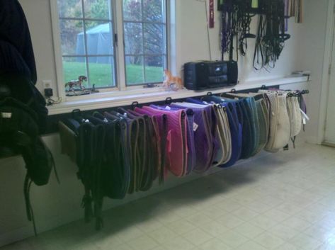 USE: Create more shelf space/allows pads to dry. Also looks neat and impressive!  NEED: Shelf bracket, thick dowel/rod, screws Diy Saddle Pad, Western Tack Room, Saddle Pad Storage, Pad Organization, Tack Room Ideas, Tack Storage, Tack Room Organization, Feed Room, Horse Tack Rooms