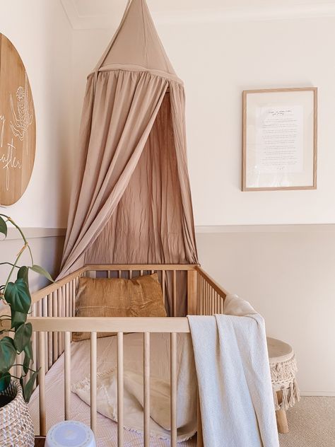 Pink cot canopy with two-toned walls, beige carpet and timber features makes a warm and calming room. Cot With Canopy, Cot Canopy Nursery, Warm Pink Nursery, Beige Nursery Girl, Beige Nursery Ideas, Beige Baby Aesthetic, Crib With Canopy, Canopy Over Crib, Nursery And Guest Room