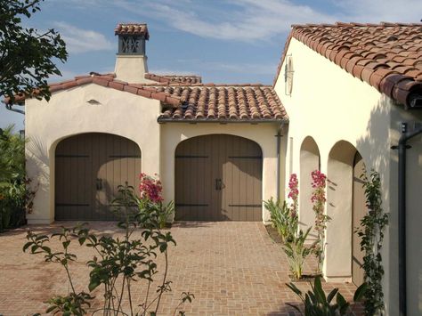 Deciding on a Garage Door | Home Remodeling - Ideas for Basements, Home Theaters & More | HGTV Mission Style Homes, Terracotta Roof, Wood Garage Doors, Garage Door Design, Spanish Style Home, Interior Remodel, Spanish Style Homes, Spanish Design, Exterior Paint Colors For House