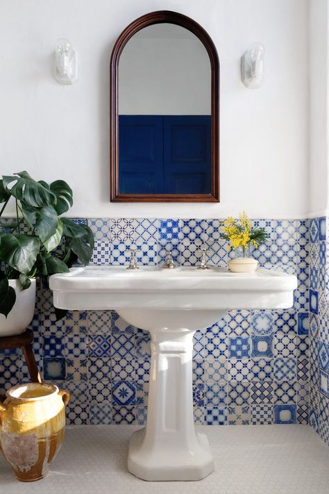 Furthering the Mediterranean aesthetic: a turn-of-the-century earthenware sink (whose outmoded configuration spurred a search for special parts) and a retired olive oil jug subbing in for a trash can. blue-tiled bathroom by White Arrow Corner Deco, Classy Apartment, Blue And White Tiles, Tile Backsplash Bathroom, Portuguese Tiles, Bright Homes, Pedestal Sink, Bathroom Backsplash, Loft Conversion