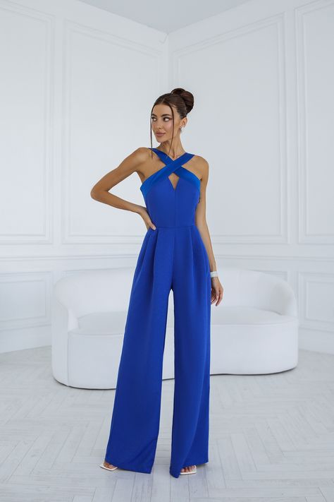 Dazzle in our Blue Cross-Neck Sleeveless Jumpsuit. The striking blue hue and chic cross-neckline combine to create an eye-catching and fashion-forward look. This jumpsuit is the epitome of modern elegance, perfect for elevating your style for any occasion. #blueoutfit #fashiondaily #fashion #clothing #style #chic #jumpsuit #womenfashion #fashionstatement #fashioninspo #eveningwear Royal Blue Formal Jumpsuit, Jumpsuit Outfit Wedding Hijab, Blue Jumpsuit Outfit Wedding, Formal Jumpsuit Prom, Jumpsuit Formal Wedding, Blue Jumpsuits Outfit, Jumpsuit Bridesmaid, Wedding Guest Jumpsuit, Jumpsuit Outfit Wedding