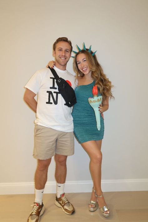 Looking for unique couples Halloween costumes for 2024? Recreate this Statue of Liberty and tourist couples costume! I dressed as Lady Liberty with an emerald green dress and headband. My fiancé had a camera, fanny pack, and tourist t-shirt to complete our NYC-themed idea. Check out my Instagram post showing our costumes in more detail. Diy Statue Of Liberty Costume, Lady Liberty Costume, Tourist Costume, Tourist Outfit, Couples Halloween Costumes, Unique Couple Halloween Costumes, Green Costumes, Emerald Green Dress, Couples Costume