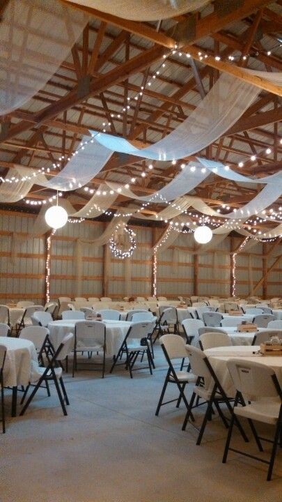 Machine Shed Wedding Reception Decor, Pole Building Wedding Reception, Shop Wedding Reception Decor, Metal Building Wedding Reception, Wedding Shed Decorations, Simple Wedding Ceiling Decorations, Boho April Wedding, Wedding Reception In Garage, Metal Shop Wedding Reception