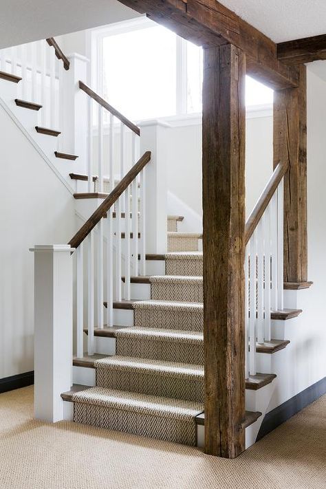 Rustic wood beams accent a white staircase contrasted with a stained railing and stained treads covered by a jute herringbone runner. Exposed Wood Beams, Small Basement Remodeling, Bria Hammel Interiors, Rustic Staircase, Bria Hammel, Stairs Railing, White Staircase, Stairs Storage, Rustic Basement