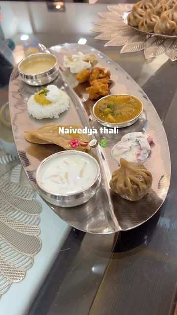 Srushti on Instagram: "Guess who’s waiting for Prasadam now? 😋 ❓Why do we present Naivedya to the idol? 🌺 Naivedya means food offerings made to god. 🌺 Naivedya offerings are made with deep reverence and devotion, symbolizing the act of surrendering to the divine. 🌺 The thali is usually placed on a circle drawn with water on the floor close to the idol’s feet. A small glass of water is placed with it on the right. 🌺 It is believed that when the offerings are presented to the deities, they p Pooja Items, Ganpati Decoration Design, Silver Pooja Items, The Idol, Ganpati Decoration, Hand Work Blouse, Glass Of Water, Silver Bowl, Hand Work Blouse Design