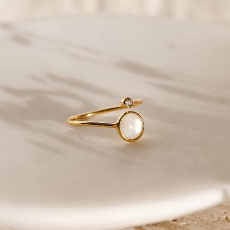 Meet your next conversation piece: A mother of pearl and white topaz ring set in a coil of gold vermeil. Ring Pearl Modern, Pearl Ring Design, Pearl Ring Gold, White Pearl Ring, Mother Of Pearl Ring, Silver Pearl Ring, Memorial Ring, Pearl Engagement Ring, Gold Pearl Ring