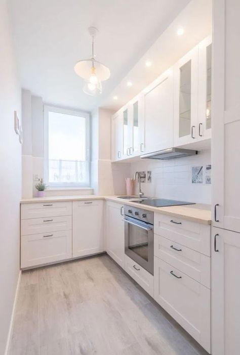 a modern white L shaped kitchen with a white tile backsplash and light stained butcherblock countertops L Shaped Kitchen Layout, L Shape Kitchen Design, Small L Shaped Kitchens, Galley Kitchen Remodel Ideas, Small Galley Kitchen, Layout Kitchen, Tiny Kitchen Design, Small Modern Kitchens, Galley Kitchen Design