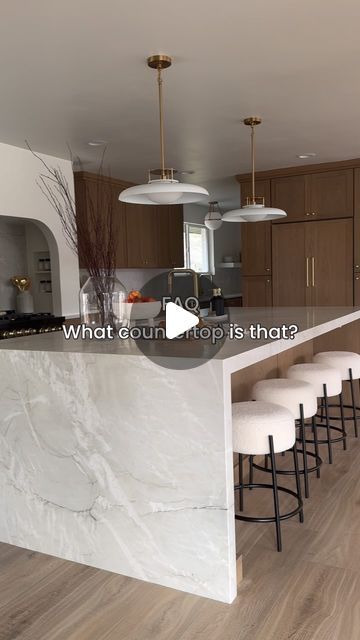 Tasha on Instagram: "The waterfall island + range slab backsplash was a must for this kitchen design. I knew I didn’t want anything too busy that could take away from the calm earthy organic feel I was going for, but it had to have character. After debating material after material I finally landed on this Bianca Superior Quartzite with a honed finish and it absolutely steals the show in this kitchen if you ask me ✨ Save this post to refer back to and more sources from this kitchen coming soon!" Quartzite Waterfall Island, Quartzite Countertops Taj Mahal, Waterfall Kitchen Island, Driftwood Kitchen, Taj Mahal Quartzite Countertops, Slab Backsplash, Waterfall Island Kitchen, Taj Mahal Quartzite, Island Range