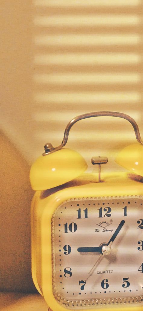 Yellow alarm clock in afternoon lighting Clock Aesthetic Wallpaper, Vintage Clock Aesthetic, Alarm Wallpaper, Yellow Alarm Clock, Alarm Clock Aesthetic, Yellow Clocks, Clock Aesthetic, Aesthetic Clock, Wallpaper Ipad